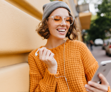 A quirky girl with a phone and a beanie